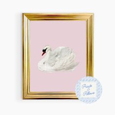 a white swan floating in the water on a pink background with a gold framed frame