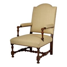 an old fashioned wooden chair with beige upholstered fabric and wood trimmings