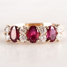 14k Yellow Gold Oval Ruby Round Diamond Cocktail Ring 1.59ctw 2.15gMetal Information: 14k Yellow GoldTotal Weight: 2.15gBand Width: 1.65mmSize: 5.75Stone InformationMain StoneGem Type: RubyShape: Oval (5.2 x 3.5mm)Color: RedClarity/Quality: AACarat Weight: .45ctNumber of Stones: 3Accent StonesGem Type: DiamondShape: Round (2.0mm)Color: GClarity/Quality: VS2Carat Weight: .03ctNumber of Stones: 8Total estimated ctw (carat total weight): 1.59ctwEstimated Retail Price: $4070.00OUR PRICE: $3255.00Siz Luxury Oval Ruby Ring In Pink Gold, 3 Ruby Ring, Luxury Art Deco Oval Ruby Ring, Luxury Oval Engraved Ruby Ring, Ruby Oval Ring, Ruby Cocktail Ring, Oval Multi-stone Ruby Ring, Colored Diamonds Rings, Ruby And Diamond Engagement Ring