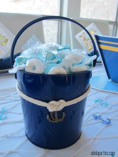 a blue bucket filled with baby items on top of a table