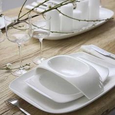 white plates and silverware on a wooden table