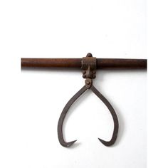 an old style hook hanging on the wall