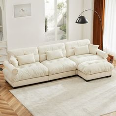 a living room with a large white sectional couch