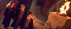 three harry potters standing in front of a fire