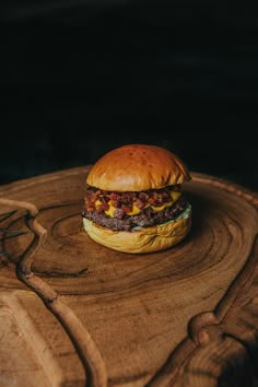 a hamburger sitting on top of a wooden table