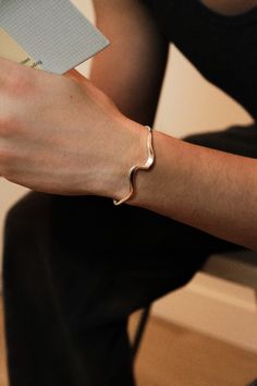 Embrace the power of the tides. Crafted from sterling silver, this curvy cuff wraps around your wrist in a sleek, wave-like motion, symbolizing the unstoppable force of momentum and reminding you to ride the waves of life with confidence and style. Whether you're exploring a coastal town or enjoying a casual brunch with friends, the Surging cuff is the perfect companion. Material: recycled sterling silver Weight: 10g Size: inclusive and adjustable, fits wrists between 5.5�” and 7.2” Waves Of Life, Coastal Town, Casual Jewelry, Sterling Silver Cuff Bracelet, Sterling Silver Cuff, Silver Cuff Bracelet, Recycled Sterling Silver, Silver Cuff, Cuff Bracelet