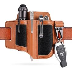 a tan leather belt with a car key hanging out of it's side pocket