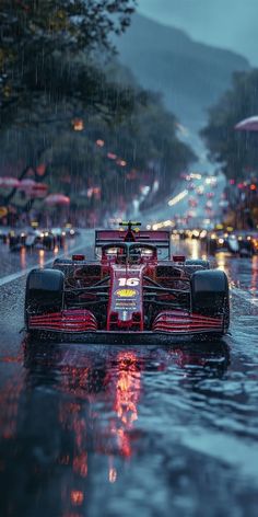 a red race car driving down the street in the rain with its lights on and it is raining