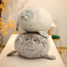 a stuffed seal sitting on top of another seal