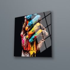 an abstract painting with multicolored hands on a black background is featured in the image