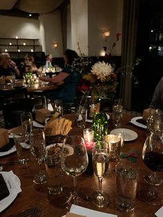 the table is set with wine glasses and plates