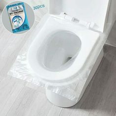 a white toilet sitting on top of a wooden floor