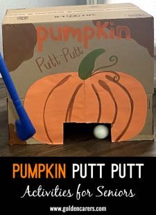 a cardboard pumpkin putt putt box with a blue plastic baseball bat in it