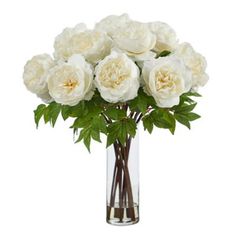 a vase filled with white flowers on top of a table