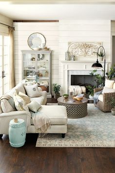 a living room filled with furniture and a fire place in the middle of a room