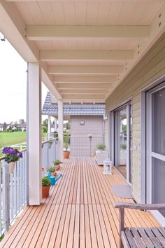 a wooden deck with potted plants on it