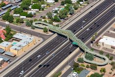 an aerial view of a freeway with cars driving on it