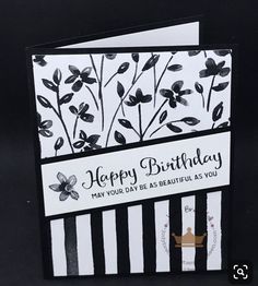 a black and white card with flowers on it