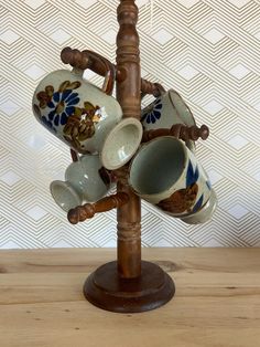 a wooden stand with several cups on it