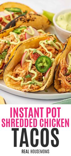 instant pot shredded chicken tacos on a plate with guacamole in the background