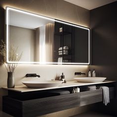 a modern bathroom with two sinks and a large mirror above the sink is lit by lights