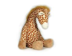 a stuffed giraffe sitting on top of a white surface