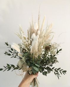 a person holding a bouquet of flowers in their hand