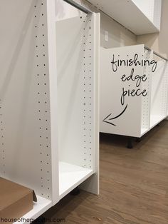 two empty white shelving units with black writing on the wall and one is labeled finishing edge piece