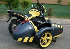 a yellow and black motorcycle parked on the street