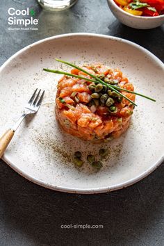 a white plate topped with food and a fork