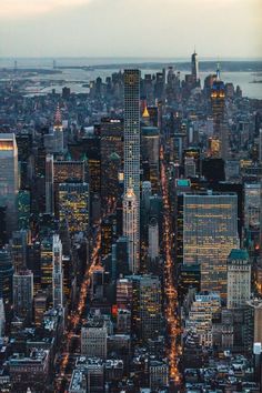 an aerial view of the city lights and skyscrapers in new york, ny at night