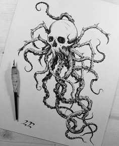 a drawing of an octopus on paper next to a pen and inking utensil