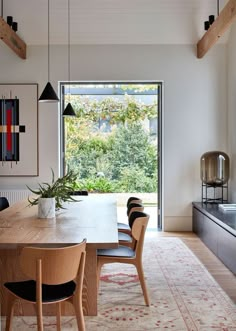 the dining room table is surrounded by black chairs