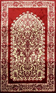 a red and white rug with an intricate design