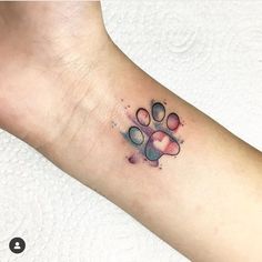 a dog paw tattoo on the wrist