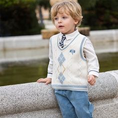 Looking good is a breeze with this adorable little vest! Elephant embroidery, argyle pattern, and a V-neck make your little dude the most stylish kid on block. Put him in the ivory knitted vest and he's ready for the day - no need to hoot and holler about it! Elephant Embroidery, Argyle Pattern, Knitted Vest, Stylish Kids, Knit Vest, White Shirt, Cable Knit, Gentleman, Elephant