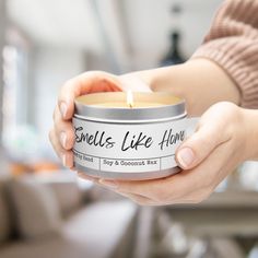 a woman holding a candle in her hand with the words smells like honey on it