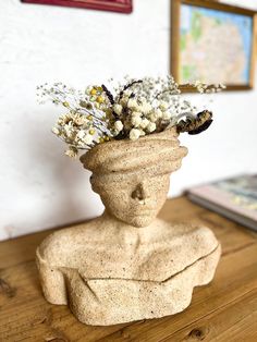 a vase with flowers in it sitting on a table