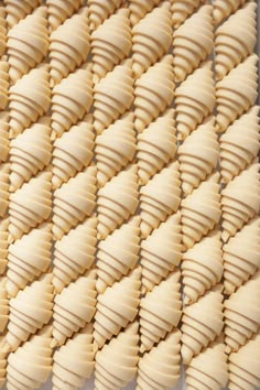 several pieces of food are arranged together on a white tablecloth with wavy lines in the middle