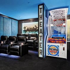 an entertainment room with two recliners and a game machine in the center,