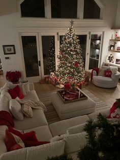 a christmas tree is lit up in the living room