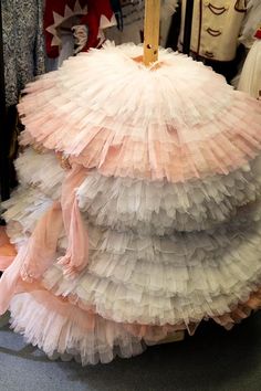 several dresses are stacked on top of each other in the shape of a ballerina