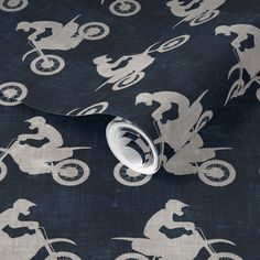 a black and white wallpaper with dirt bike silhouettes on the back side of it