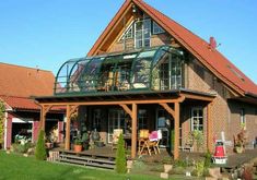 a large house with a glass roof and balcony