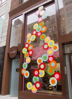 a store window with colorful circles on it