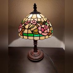 a stained glass lamp sitting on top of a table