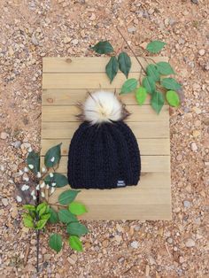 Are you ready for cold weather? Donyoubhave a ski trip planned and need a cozy but cute beanie? Keep cozy, warm and trendy in this hand knit winter hat. A fitted ribbed knit winter beanie with a fluffy Faux Fur pom pom and black Faux Leather tag. Made from a 50% Wool , 50% Acrylic blend yarn. Fits head circumference 20 to 22 inches. Care Instructions: Hand wash and lay flat to dry out of the direct sun. Do not submerge pom. Processing Time: Made To Order, Ships in 1-2 weeks. Every item is carefully handmade in a smoke free home. Please Note: Colors from screen to screen can vary due to setting differences. Please Contact Me with ANY Questions You May Have! Thank You For Supporting Handmade! Black Ribbed Knit Beanie with Faux Fur Pom, Women's Wool Blend Knit Beanie, Chunky Knit Beanie, Wome Cozy Cable Knit Crochet Hat For Winter, Winter Yarn Bonnet For Cold Weather, Yarn Bonnet For Cold Winter Weather, Soft Knit Yarn Bonnet For Cold Weather, Yarn Bonnet For Cold Weather In Fall, Crochet Hat For Cold Weather, One Size Crochet Hat For Winter Cold Weather, Warm Crochet Hat For Fall And Cold Weather, Warm Crochet Hat For Cold Weather In Fall