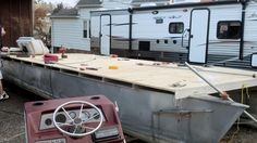 a trailer that is sitting in the street next to some trailers and people standing around it