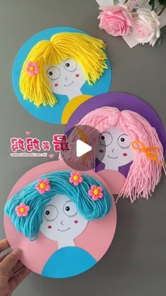 three paper plates decorated with children's faces and flowers on top of a table