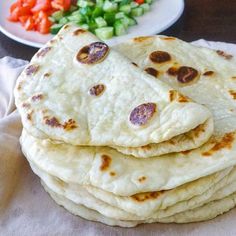 four flatbreads stacked on top of each other with the words easy yogurt flatbreads using just 2 basic ingredients